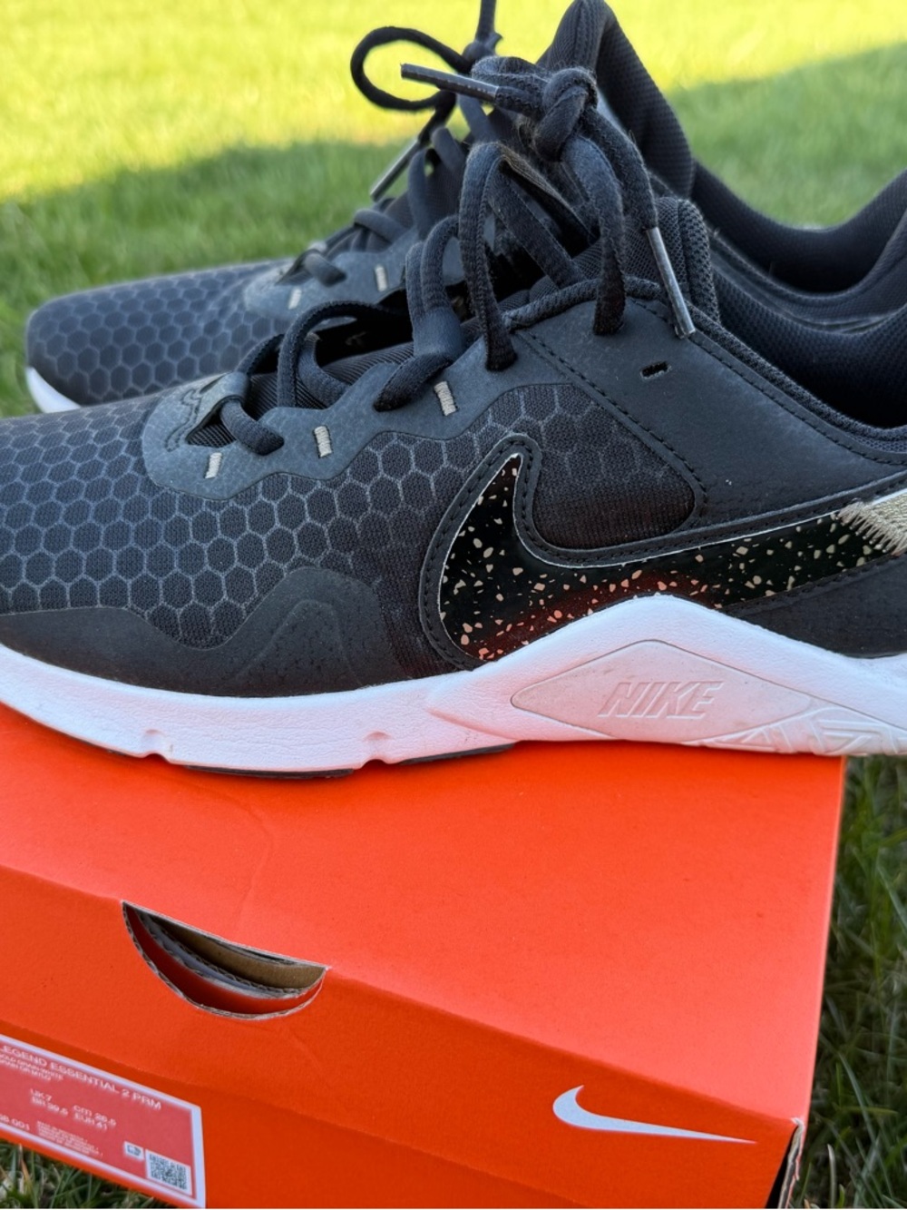 Nike Legend Essential 2 women’s training shoes in black and gold